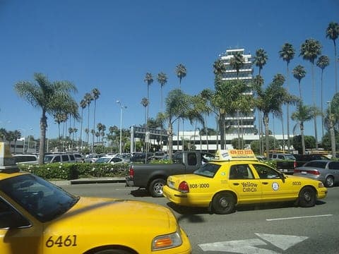 Gelbe Taxis auf einer Straße mit Palmen in Los Angeles